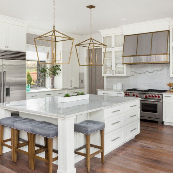 Open concept kitchen with white marble backsplash and countertops
