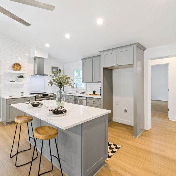Kitchen with grey cabinets and warm laminate flooring
